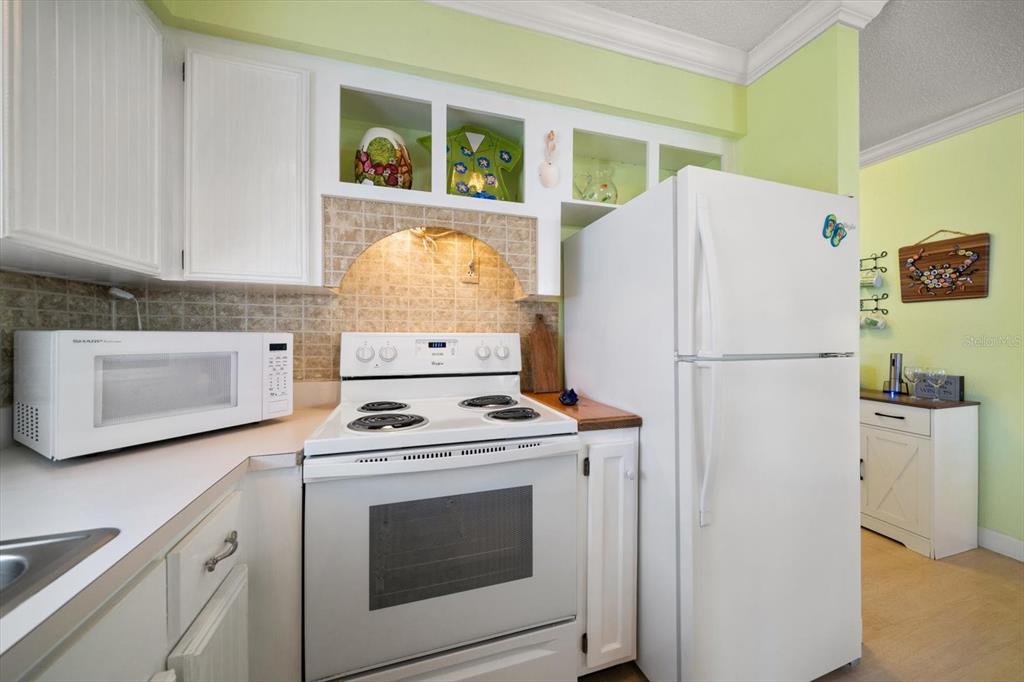 800 East Gulf Boulevard, Unit 5 Indian Rocks Beach, FL 33785 - Photo 15 of 52 a white refrigerator freezer and a stove sitting inside of a kitchen