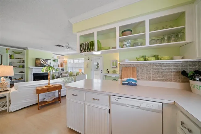 a kitchen with kitchen island a large counter top space and stainless steel appliances