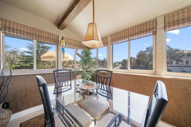a dining room with furniture a chandelier and wooden floor