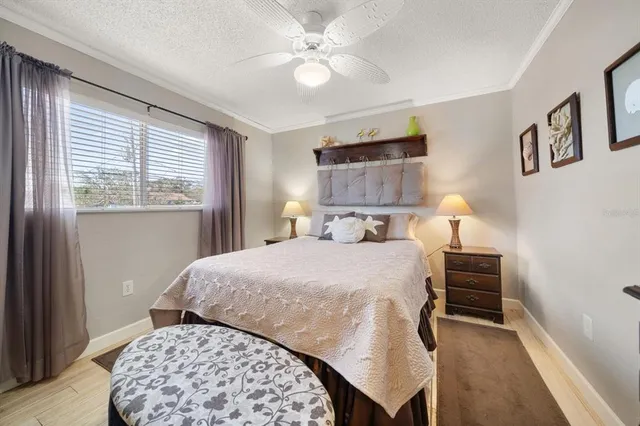 a large bedroom with a bed and a chandelier