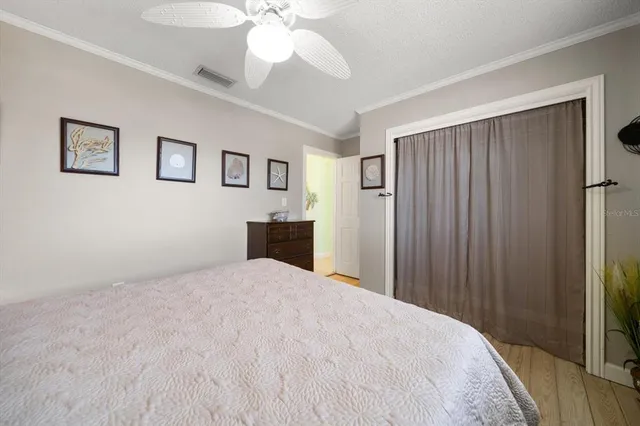 a spacious bedroom with two beds and a chandelier