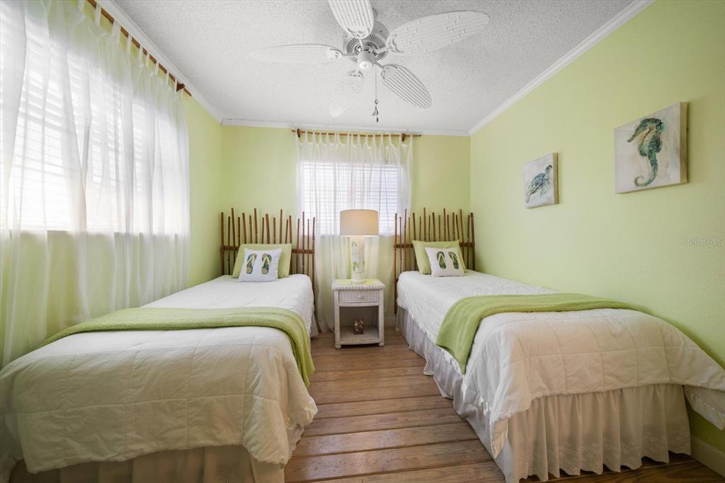 800 East Gulf Boulevard, Unit 5 Indian Rocks Beach, FL 33785 - Photo 30 of 52 a bedroom with two beds and a chandelier