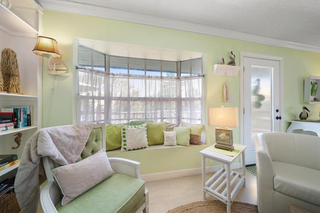 800 East Gulf Boulevard, Unit 5 Indian Rocks Beach, FL 33785 - Photo 7 of 52 a living room with furniture and a large window