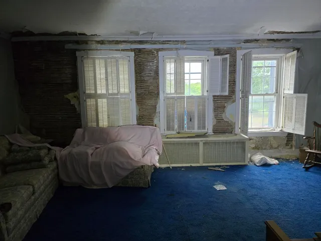 a bedroom with furniture and a window
