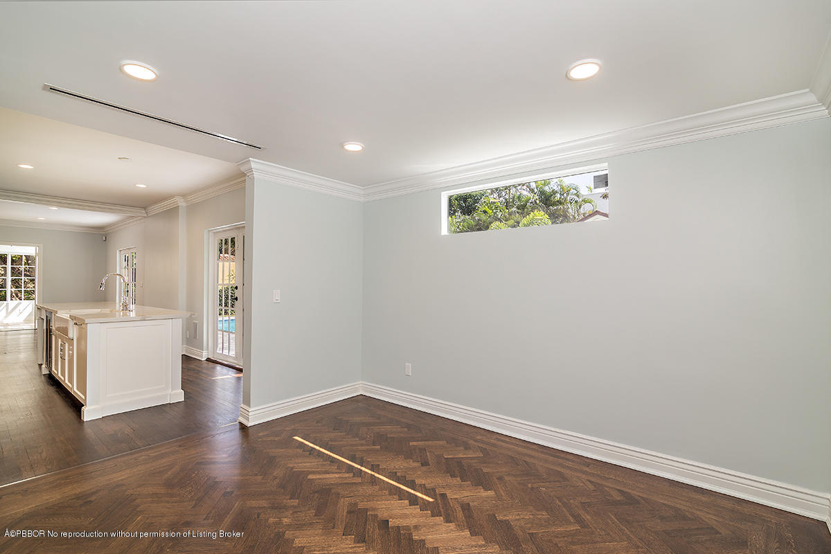 230 Murray Road West Palm Beach, FL 33405 - Photo 12 of 33 an empty room with wooden floor and kitchen view