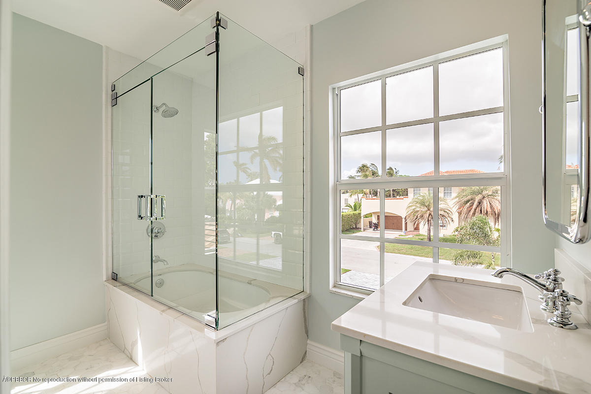 230 Murray Road West Palm Beach, FL 33405 - Photo 17 of 33 a bathroom with a tub sink and large window