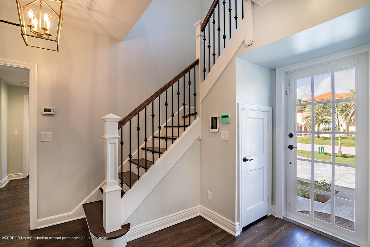 230 Murray Road West Palm Beach, FL 33405 - Photo 4 of 33 a view of staircase with wooden floor and white walls