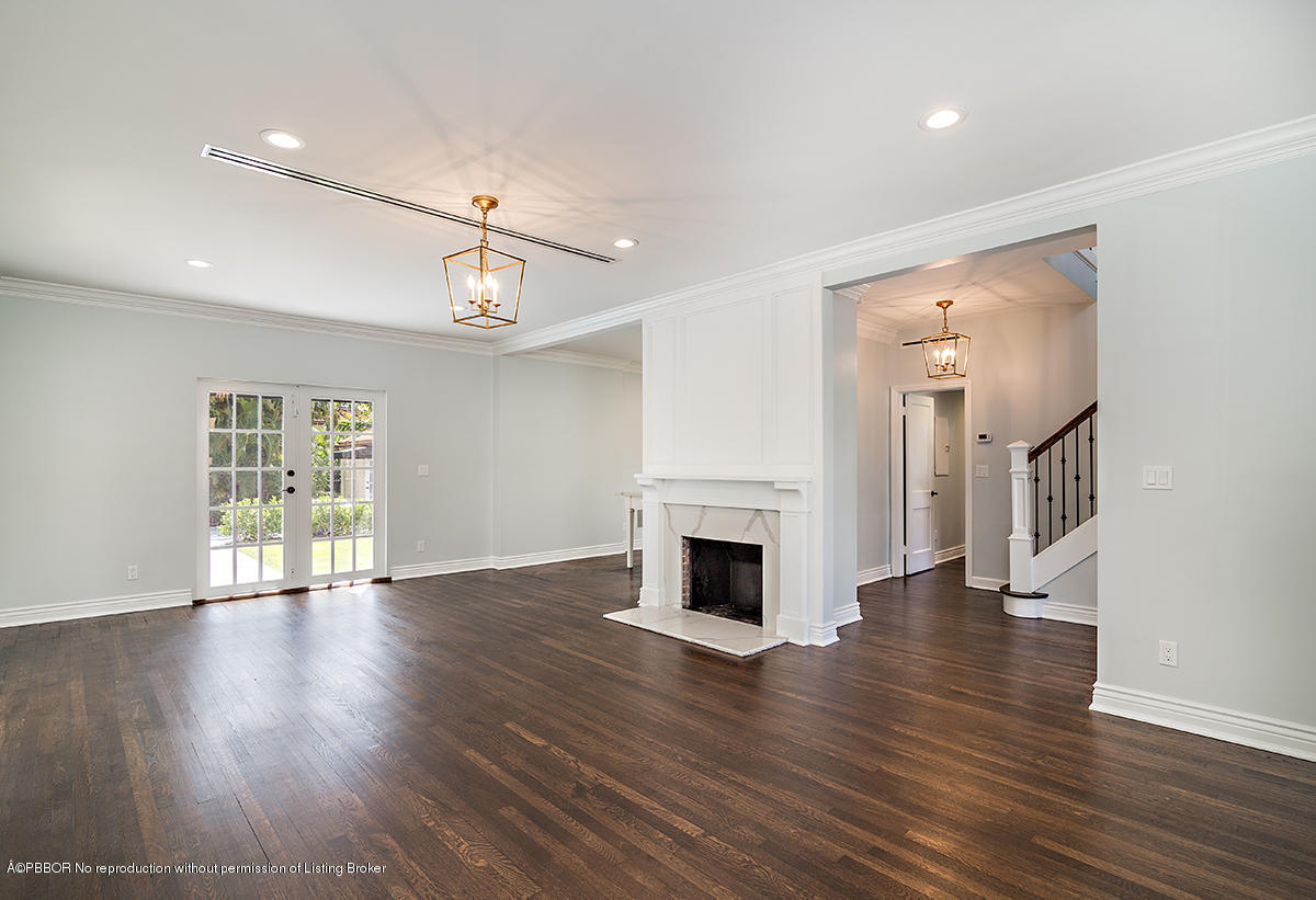 230 Murray Road West Palm Beach, FL 33405 - Photo 6 of 33 a view of an empty room with wooden floor fireplace and a window
