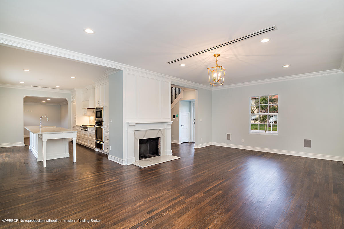 230 Murray Road West Palm Beach, FL 33405 - Photo 7 of 33 an empty room with wooden floor fireplace and windows