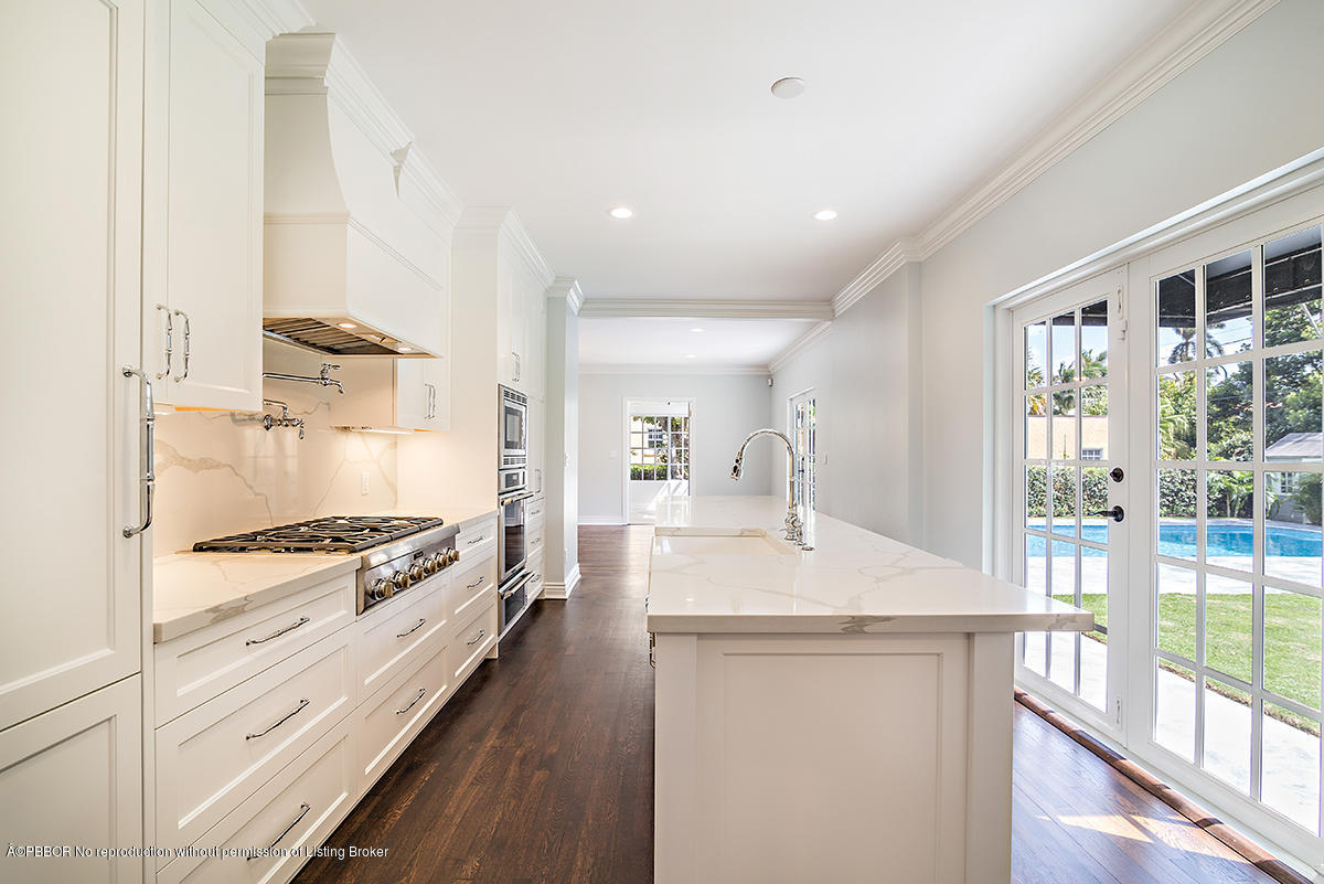 230 Murray Road West Palm Beach, FL 33405 - Photo 10 of 33 a kitchen with granite countertop white cabinets and white appliances