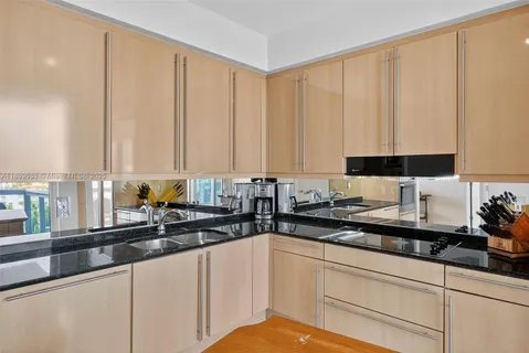 a kitchen with stainless steel appliances a sink a counter space and cabinets