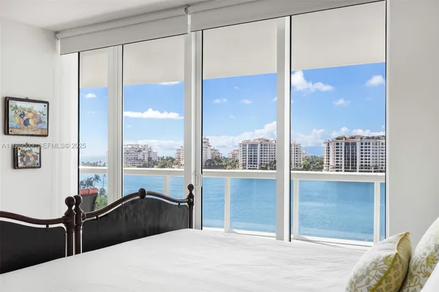 a bedroom with a large window and a bed