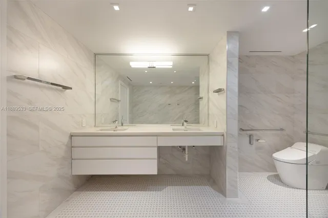 a bathroom with a bathtub shower sink and toilet