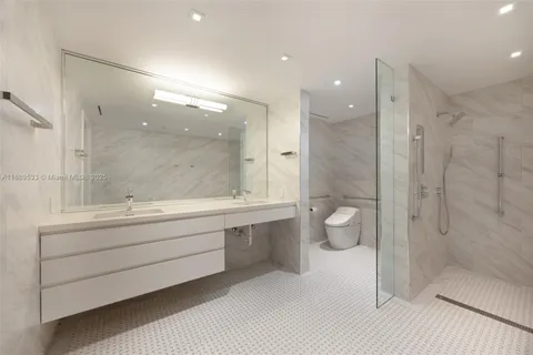 a bathroom with a double vanity sink toilet and shower