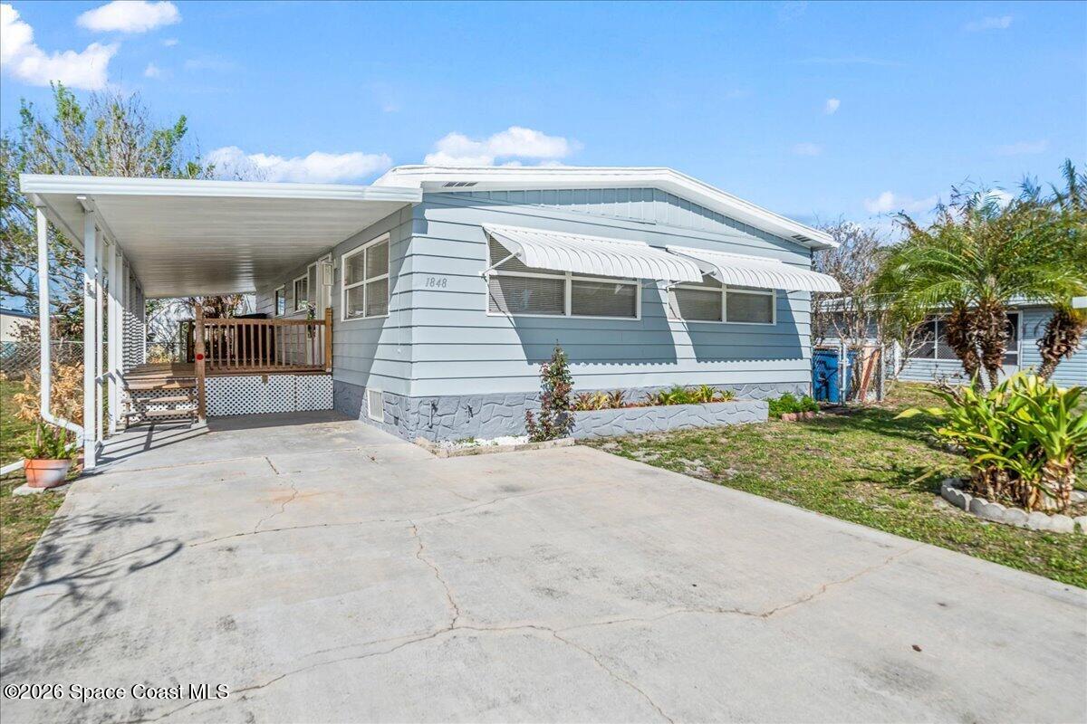1848 Seagrape Street Northeast Palm Bay, FL 32905 - Photo 1 of 27 a view of house with outdoor space and porch