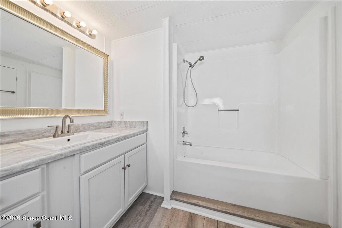 1848 Seagrape Street Northeast Palm Bay, FL 32905 - Photo 11 of 27 a bathroom with a granite countertop sink a toilet and shower