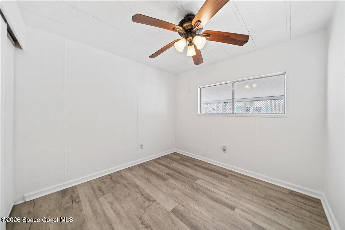 1848 Seagrape Street Northeast Palm Bay, FL 32905 - Photo 13 of 27 an empty room with a window and a fan