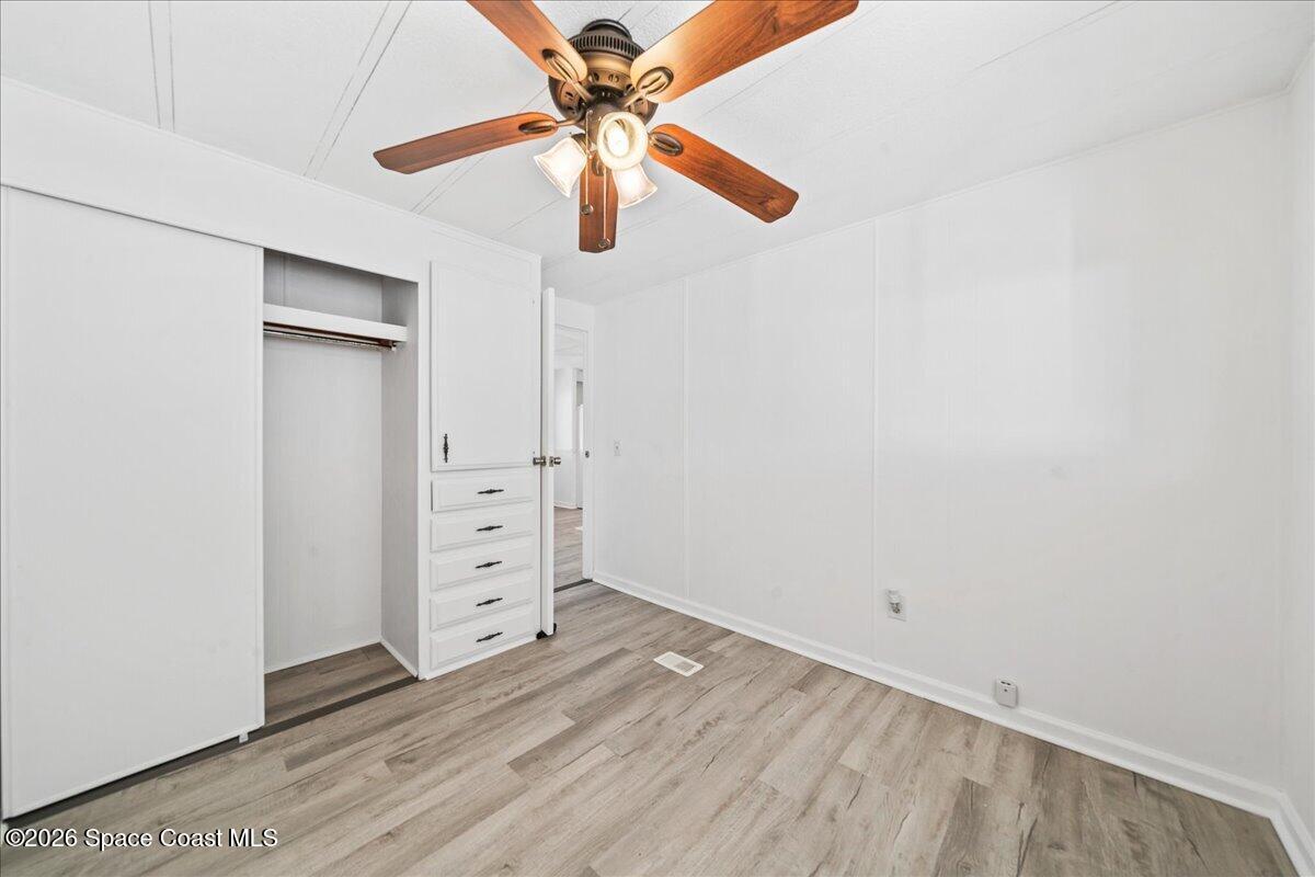 1848 Seagrape Street Northeast Palm Bay, FL 32905 - Photo 16 of 27 an empty room with windows and fan