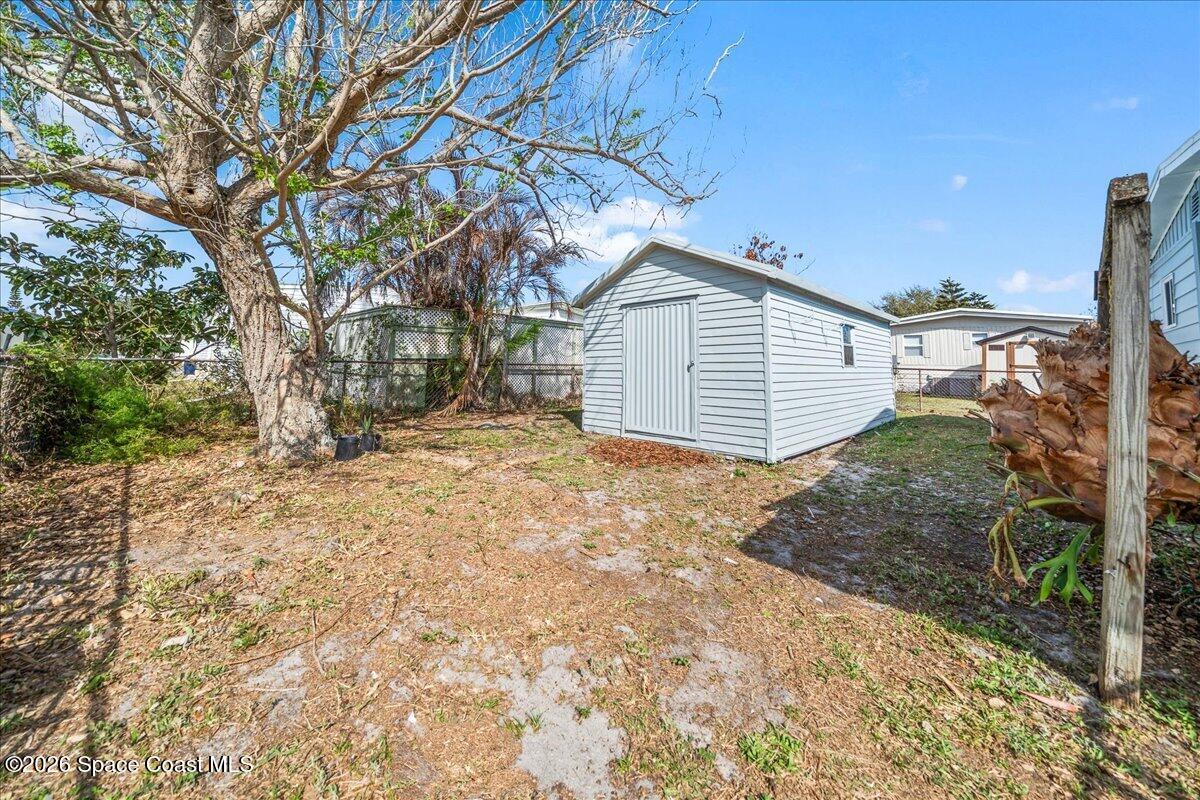 1848 Seagrape Street Northeast Palm Bay, FL 32905 - Photo 22 of 27 a view of a house with a yard and garage