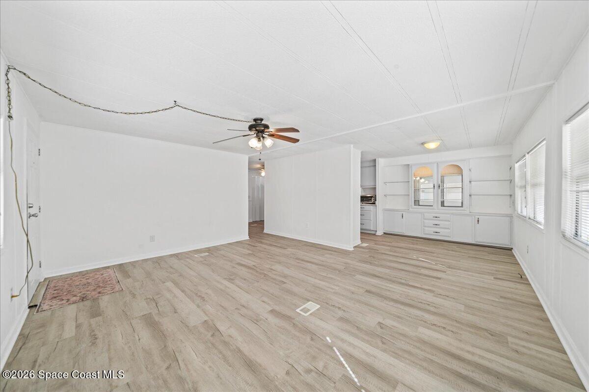 1848 Seagrape Street Northeast Palm Bay, FL 32905 - Photo 4 of 27 a view of empty room with wooden floor and fan