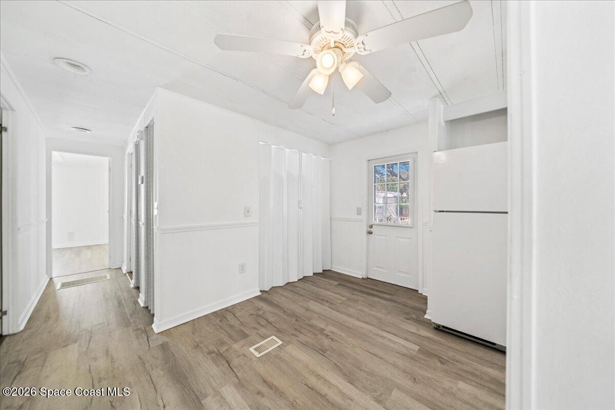 1848 Seagrape Street Northeast Palm Bay, FL 32905 - Photo 8 of 27 wooden floor in an empty room with a window