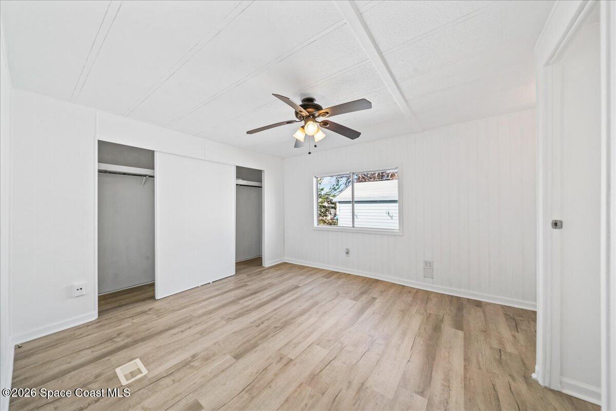 1848 Seagrape Street Northeast Palm Bay, FL 32905 - Photo 9 of 27 wooden floor in an empty room with a window