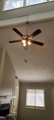 a view of a livingroom with a ceiling fan and window