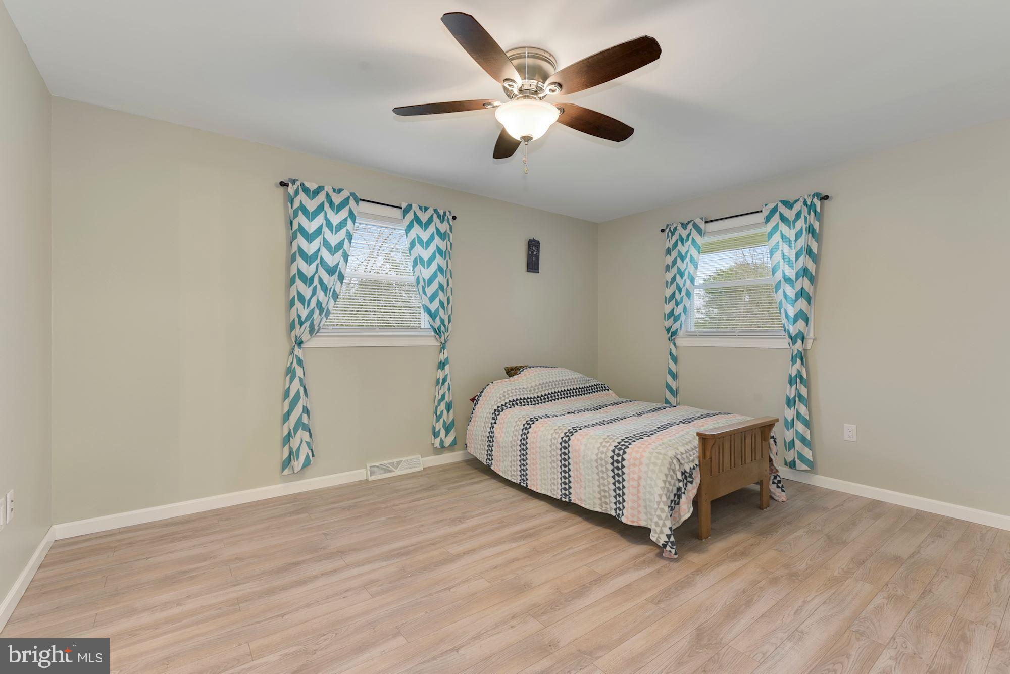 221 Arneys Mt Road Pemberton, NJ 08068 - Photo 11 of 28 a bedroom with a bed and a ceiling fan
