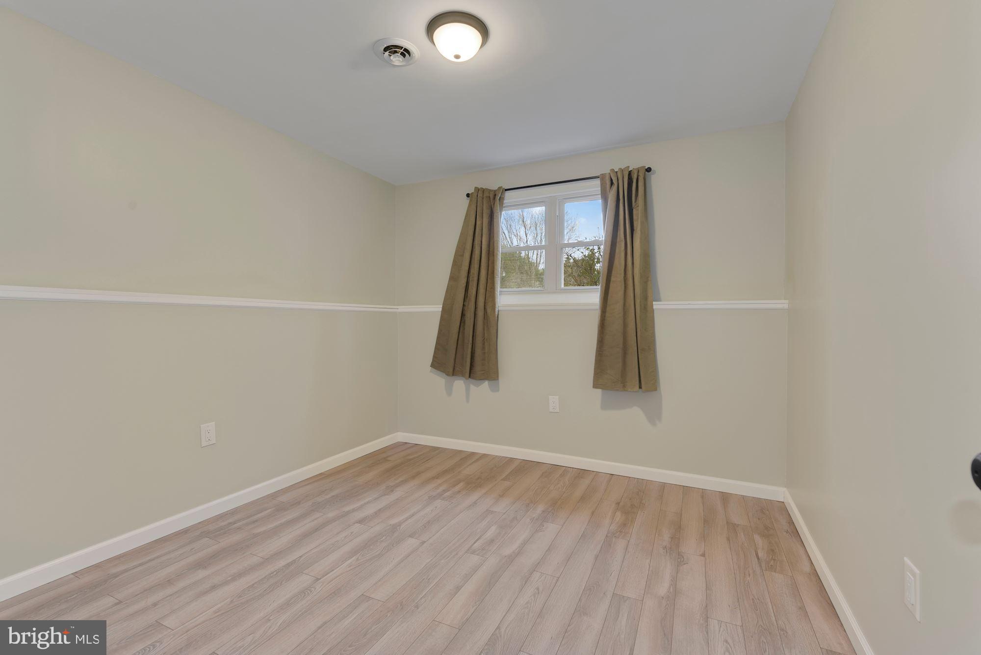 221 Arneys Mt Road Pemberton, NJ 08068 - Photo 16 of 28 an empty room with wooden floor and windows