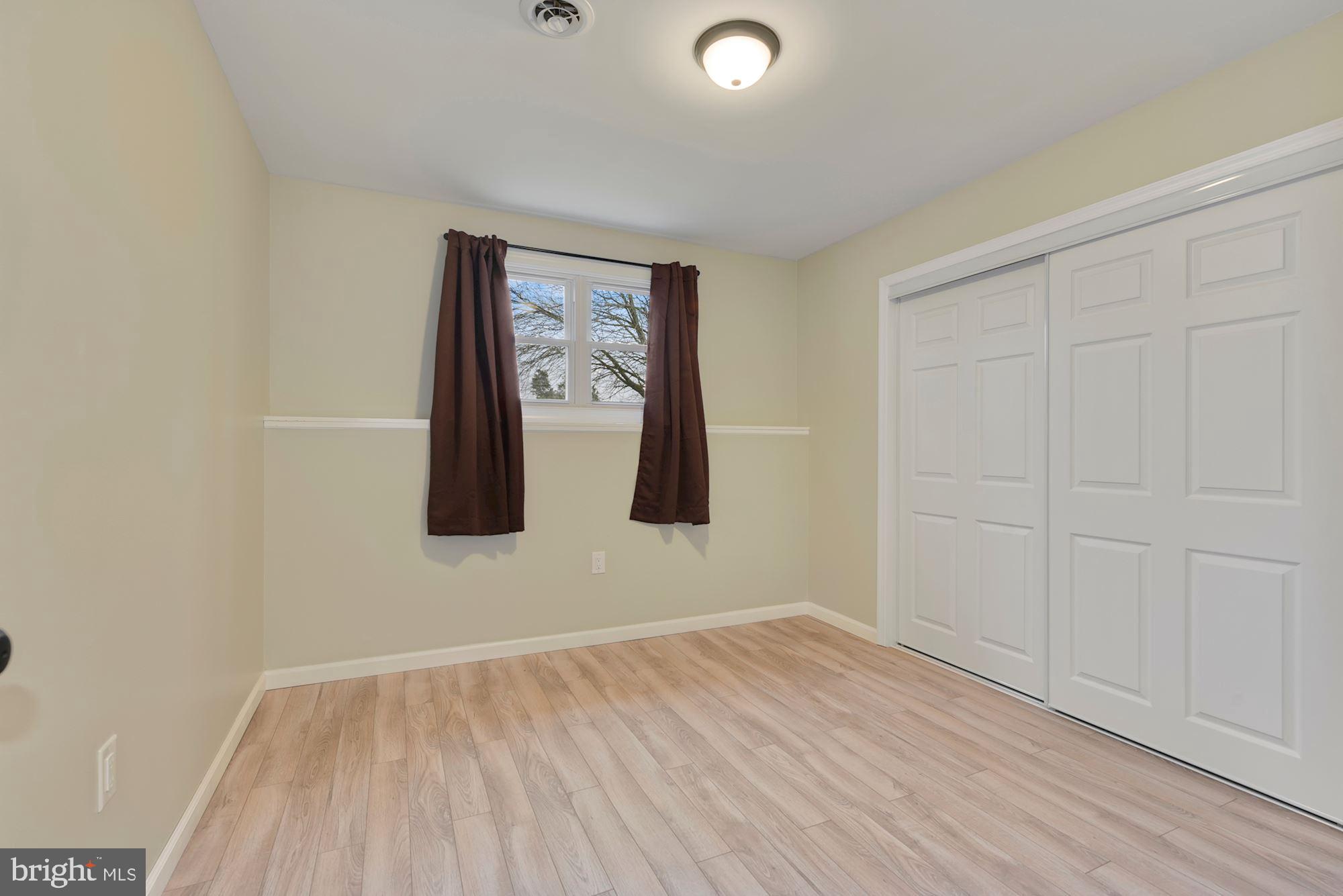 221 Arneys Mt Road Pemberton, NJ 08068 - Photo 18 of 28 an empty room with wooden floor and closet