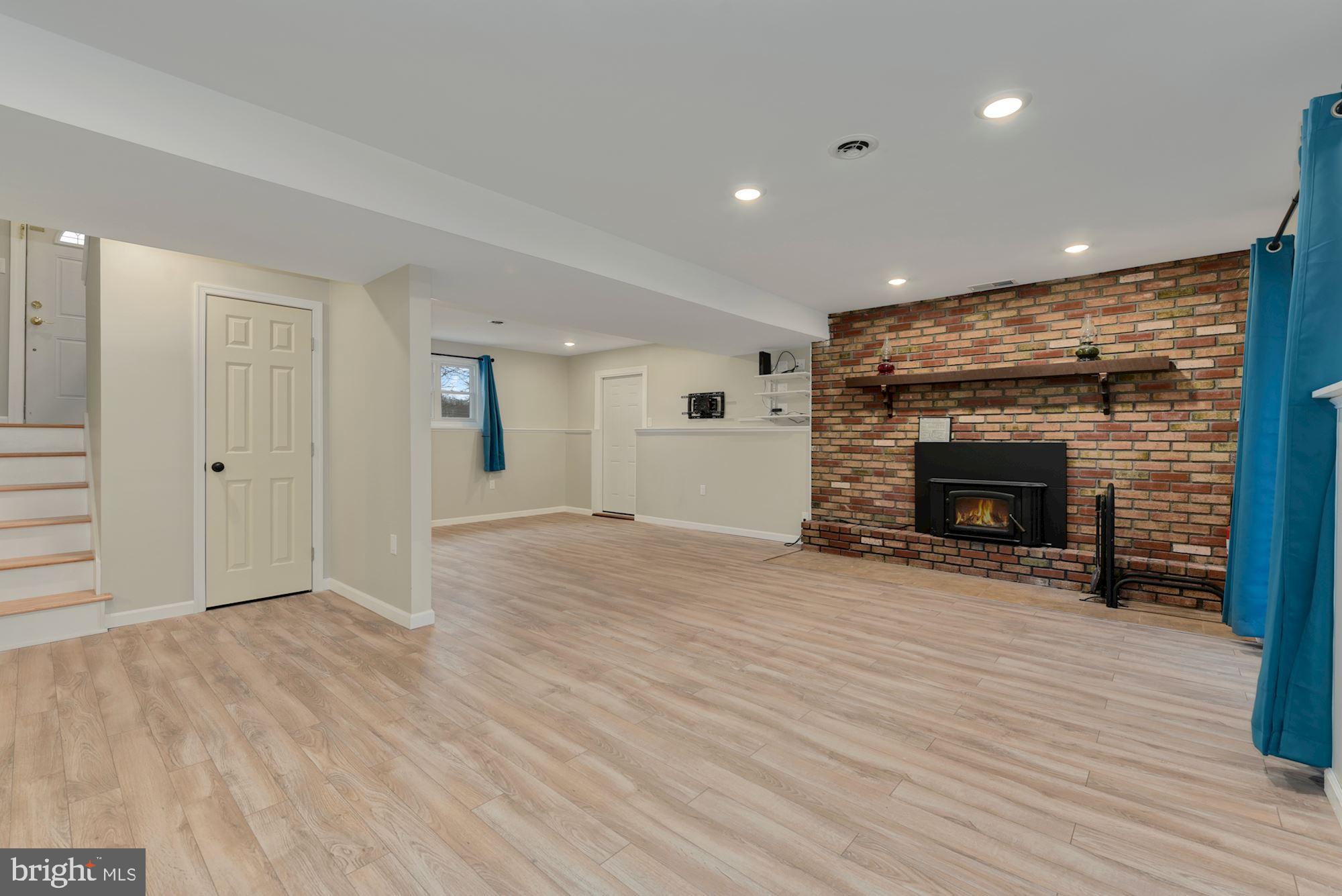 221 Arneys Mt Road Pemberton, NJ 08068 - Photo 21 of 28 an empty room with wooden floor and fireplace