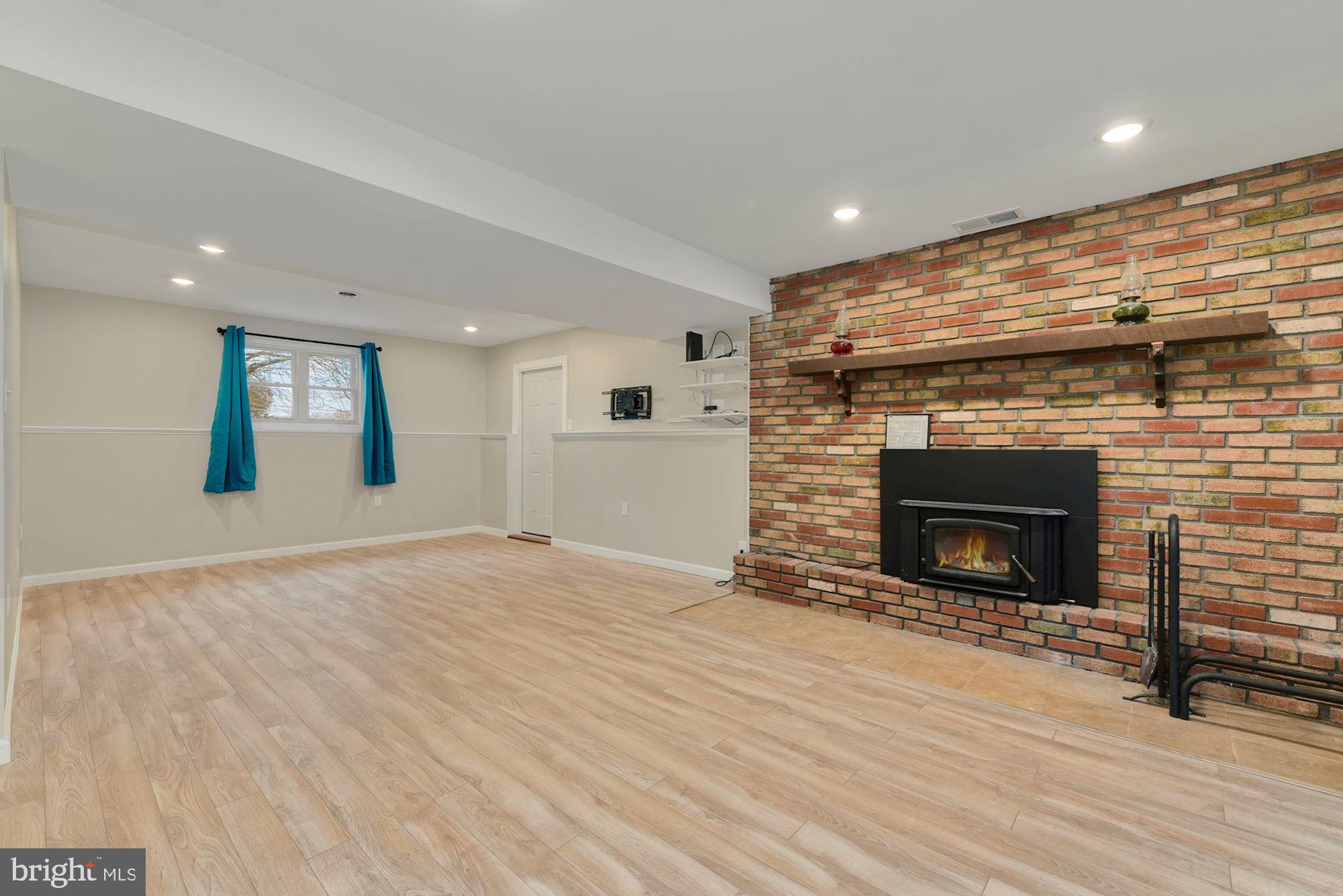 221 Arneys Mt Road Pemberton, NJ 08068 - Photo 22 of 28 a view of a livingroom with wooden floor and a fireplace