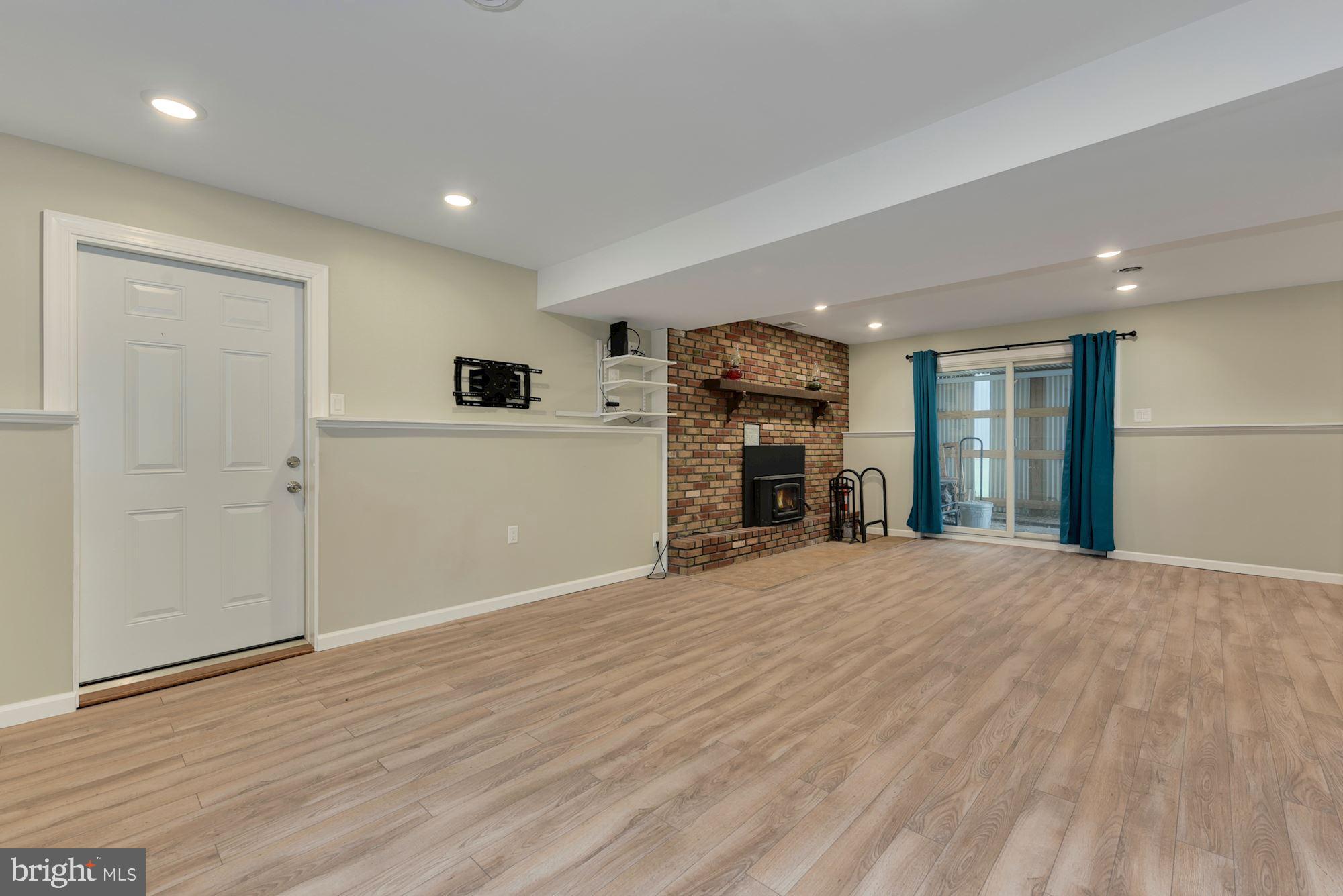 221 Arneys Mt Road Pemberton, NJ 08068 - Photo 23 of 28 a view of empty room with wooden floor and fireplace