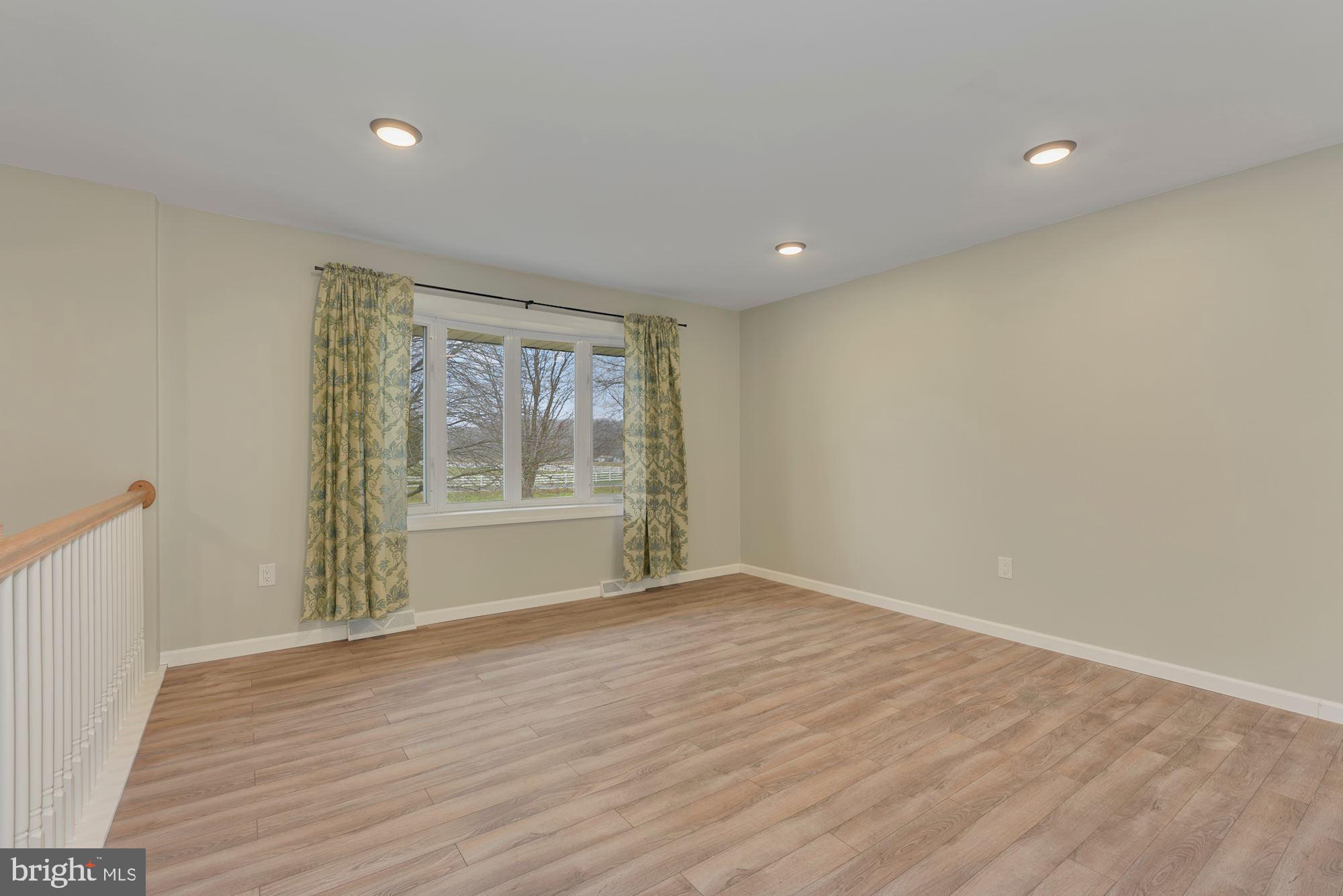221 Arneys Mt Road Pemberton, NJ 08068 - Photo 4 of 28 a view of an empty room with wooden floor and a window