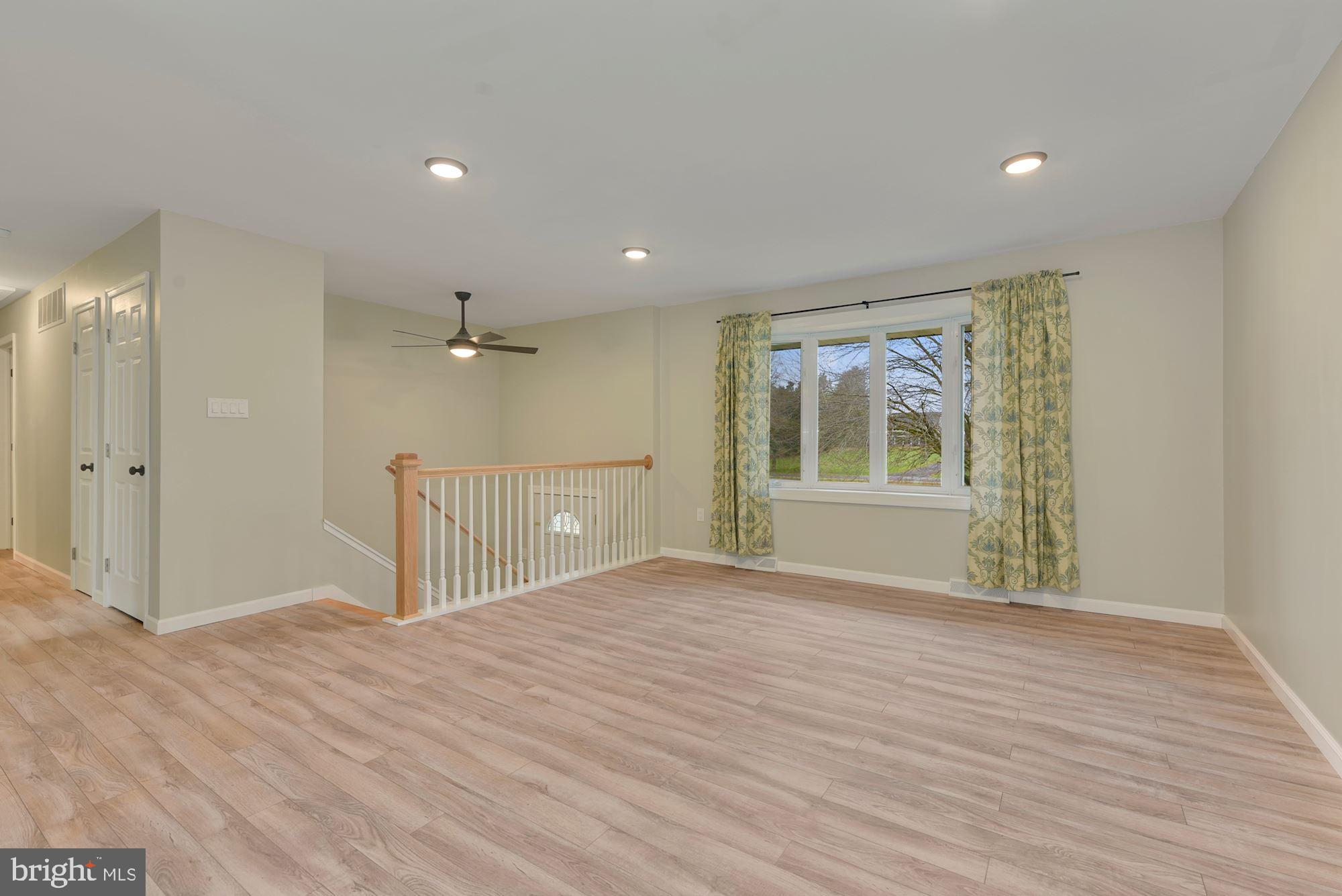 221 Arneys Mt Road Pemberton, NJ 08068 - Photo 5 of 28 a view of an empty room with a window and wooden floor