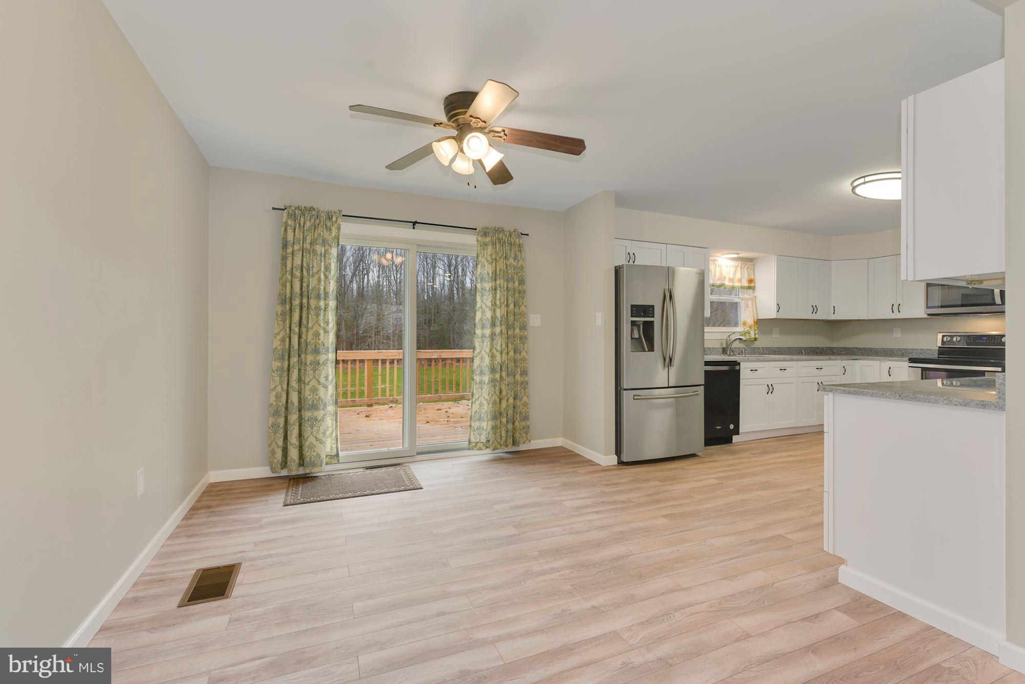 221 Arneys Mt Road Pemberton, NJ 08068 - Photo 7 of 28 a kitchen with granite countertop a refrigerator and white cabinets