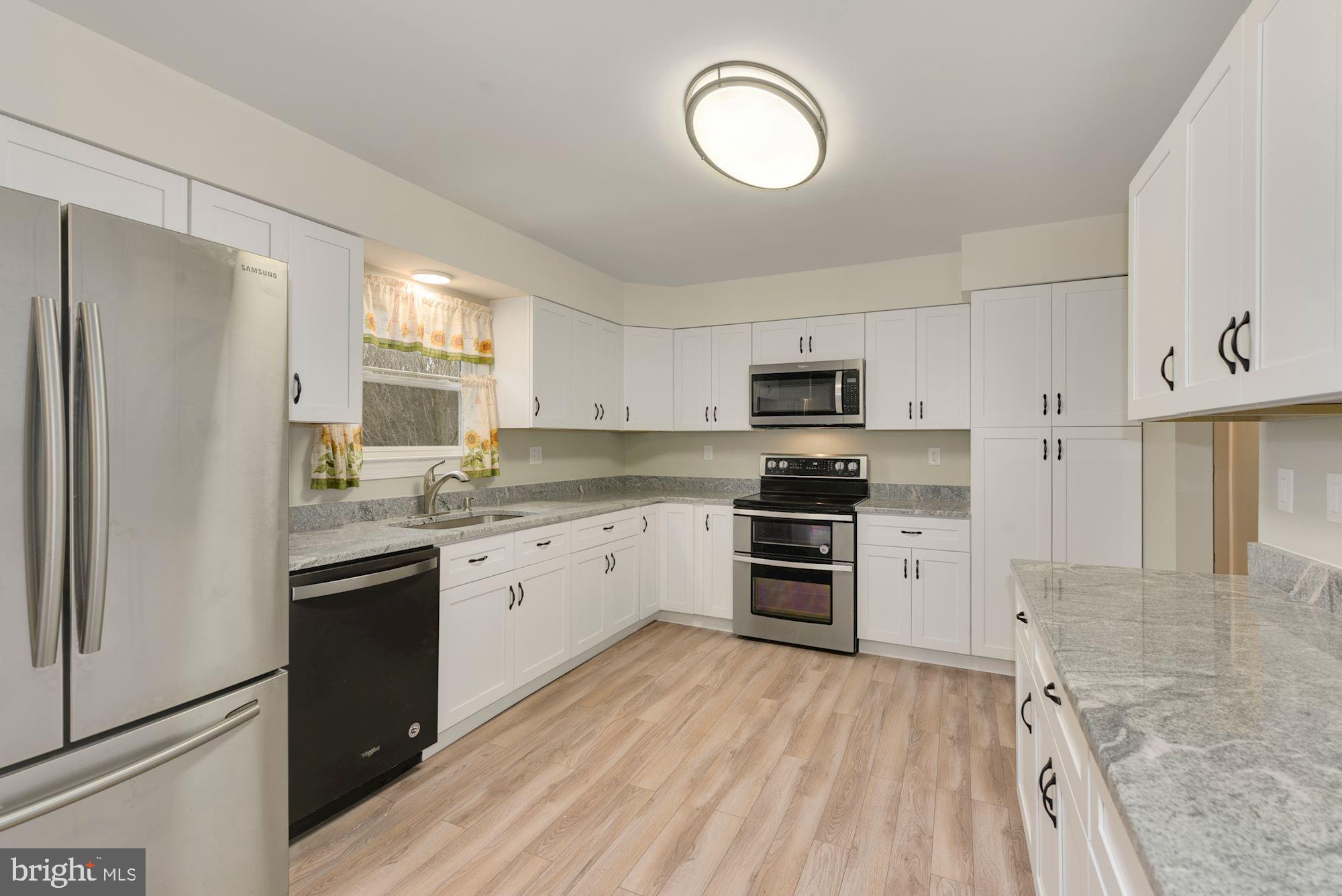 221 Arneys Mt Road Pemberton, NJ 08068 - Photo 9 of 28 a kitchen with granite countertop a refrigerator stove top oven and sink