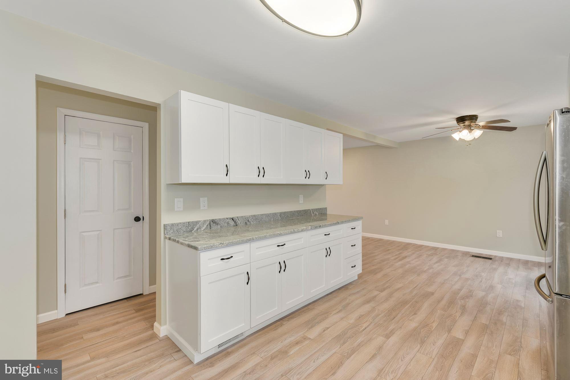221 Arneys Mt Road Pemberton, NJ 08068 - Photo 10 of 28 a kitchen with granite countertop a stove and a wooden floors