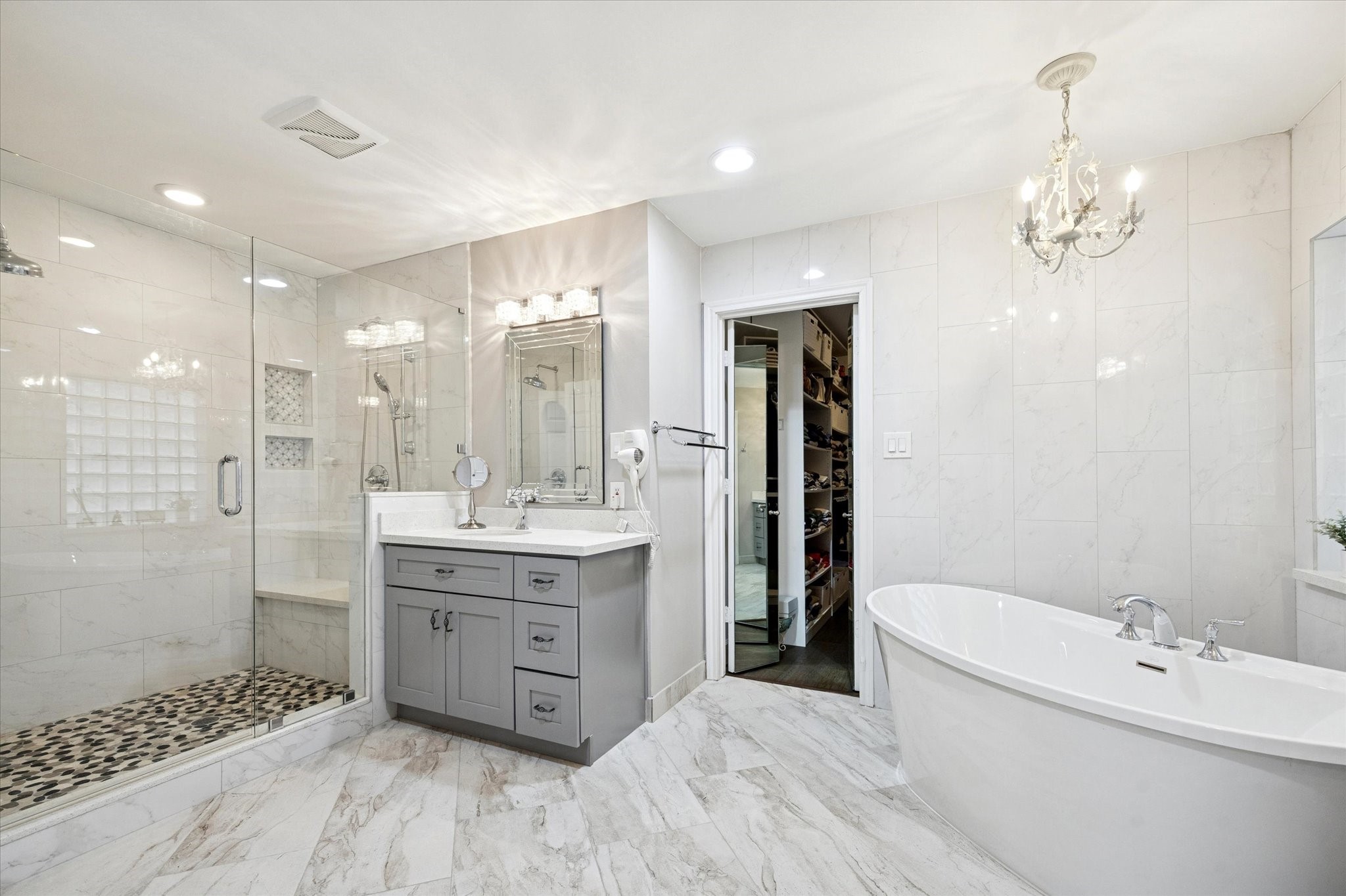 a bathroom with a double vanity sink mirror and shower