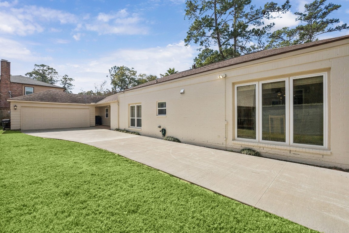 242 Vanderpool Lane Houston, TX 77024 - Photo 34 of 45 This photo showcases a new driveway set behine an electric gate. The garage has a new epoxy flooring, new garage door opener, recent EV charging station and a recent electrical panel. Garage measures 21x20.