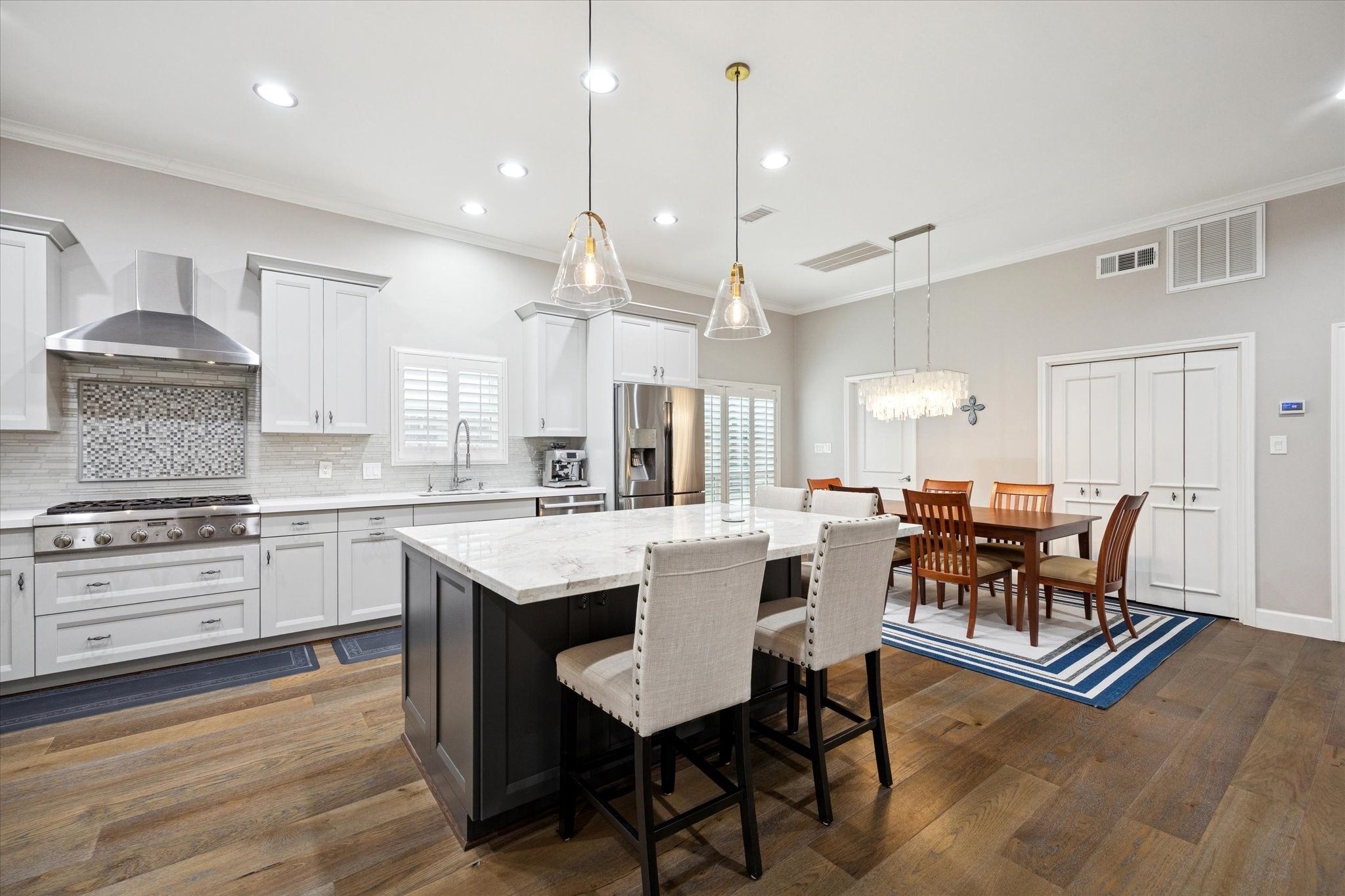 242 Vanderpool Lane Houston, TX 77024 - Photo 7 of 45 This bright, modern kitchen features sleek cabinetry and Thermador appliances. The open layout flows into the formal dining area and is open to the family room with views of the patio area.