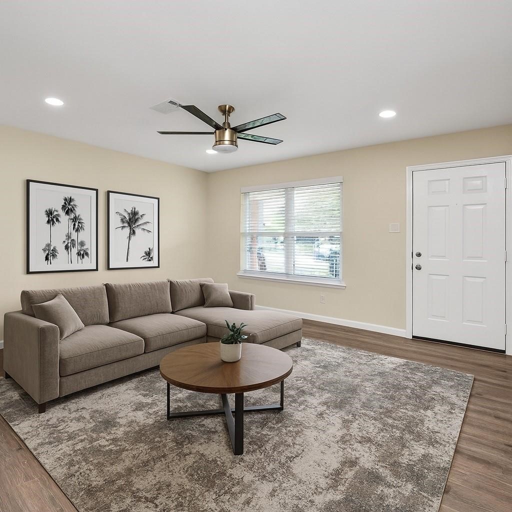 a living room with furniture a rug and a window