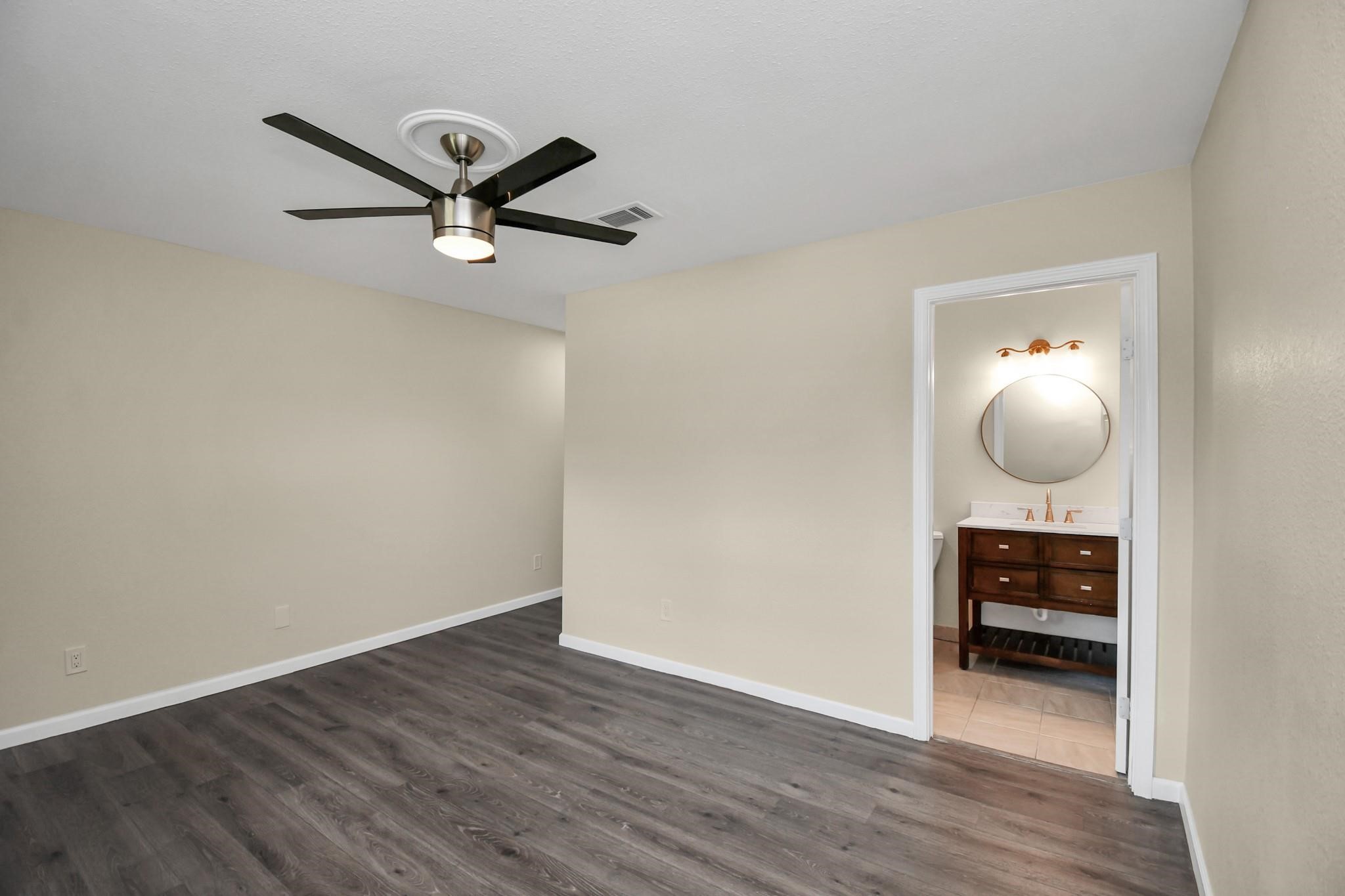 531 Edgebrook Drive Houston, TX 77034 - Photo 17 of 26 a view of a livingroom with wooden floor and a ceiling fan
