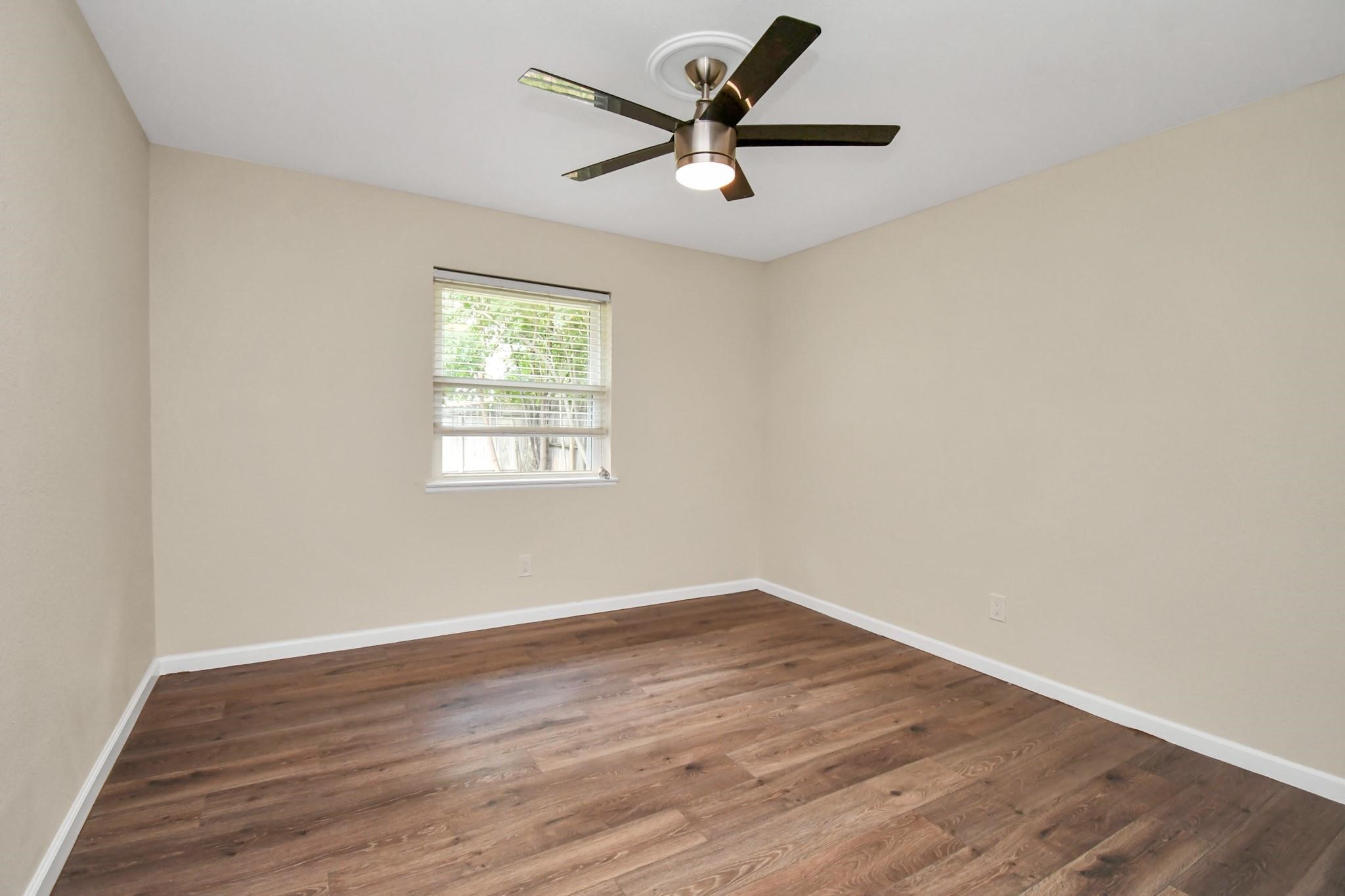 531 Edgebrook Drive Houston, TX 77034 - Photo 18 of 26 an empty room with wooden floor and windows