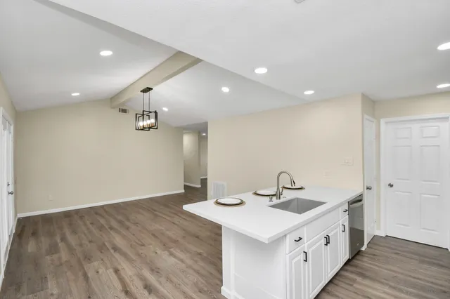 a kitchen with a sink and a refrigerator