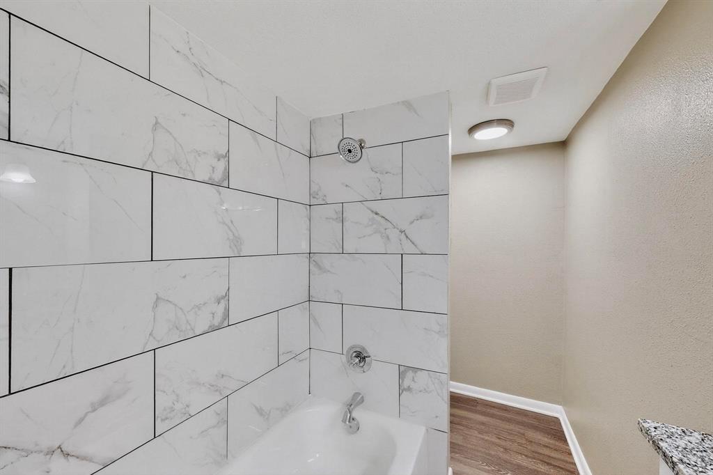 3112 Red River Street Melissa, TX 75454 - Photo 19 of 40 Bathroom featuring shower / tub combination, a textured wall, and wood finished floors