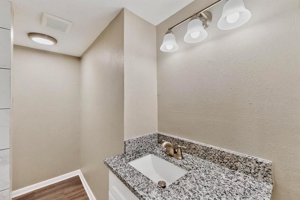 3112 Red River Street Melissa, TX 75454 - Photo 20 of 40 Bathroom featuring vanity, a textured wall, and dark wood finished floors