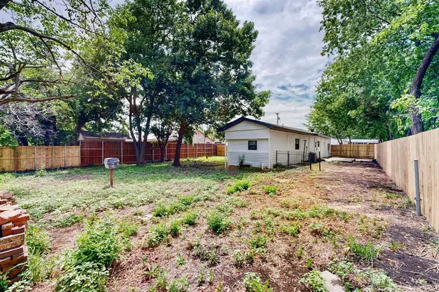 a backyard of a house with a garden and deck