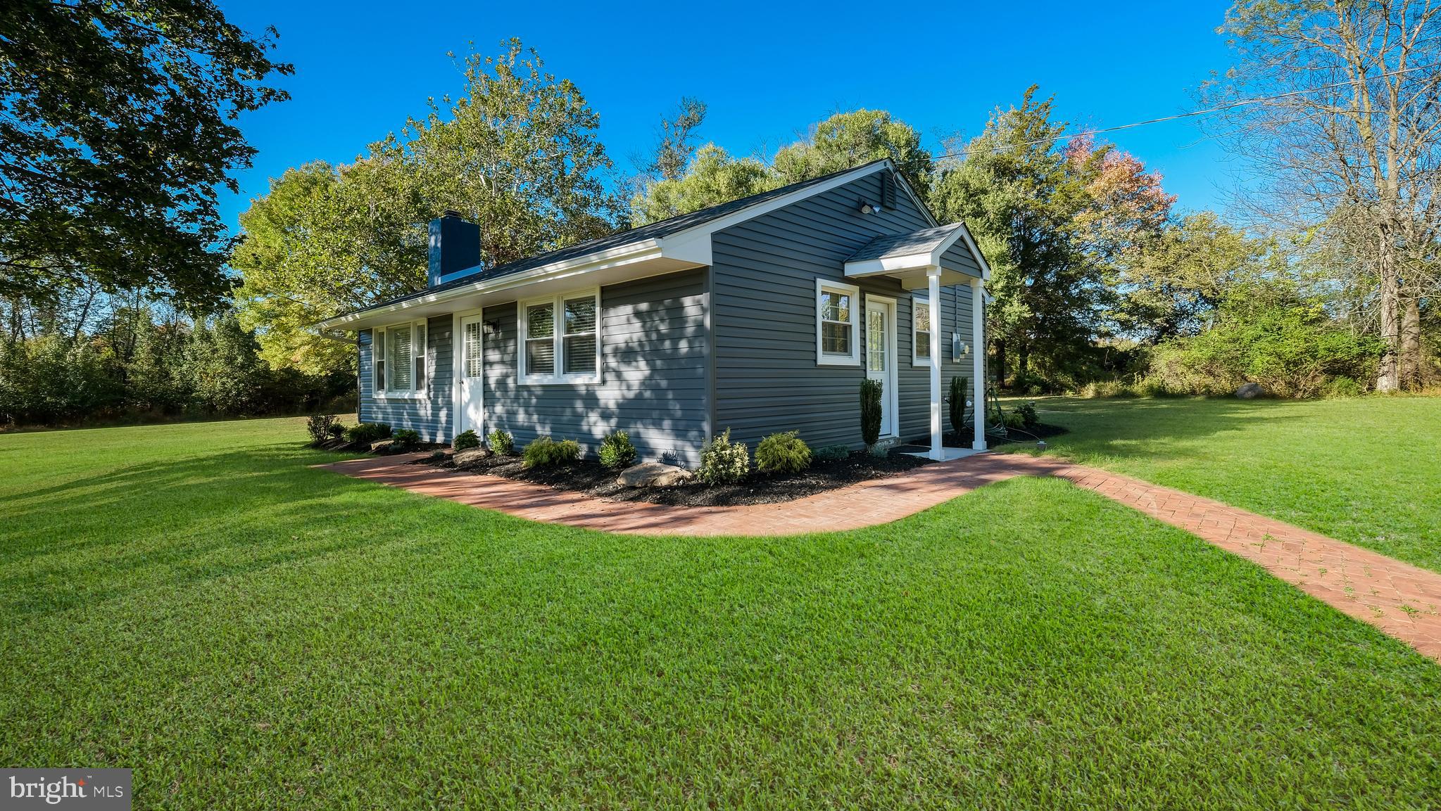 a front view of house with yard and green space
