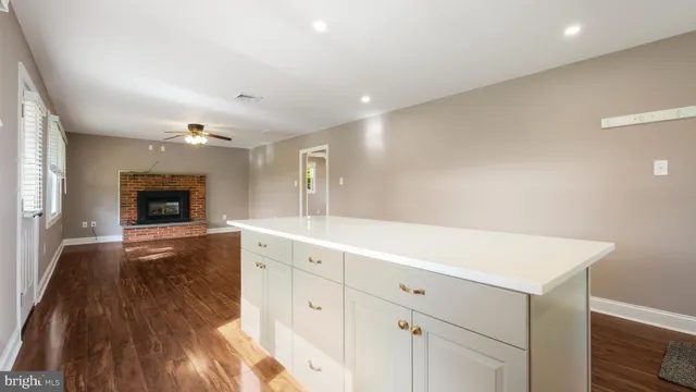 a view of a kitchen counter space and wooden floor